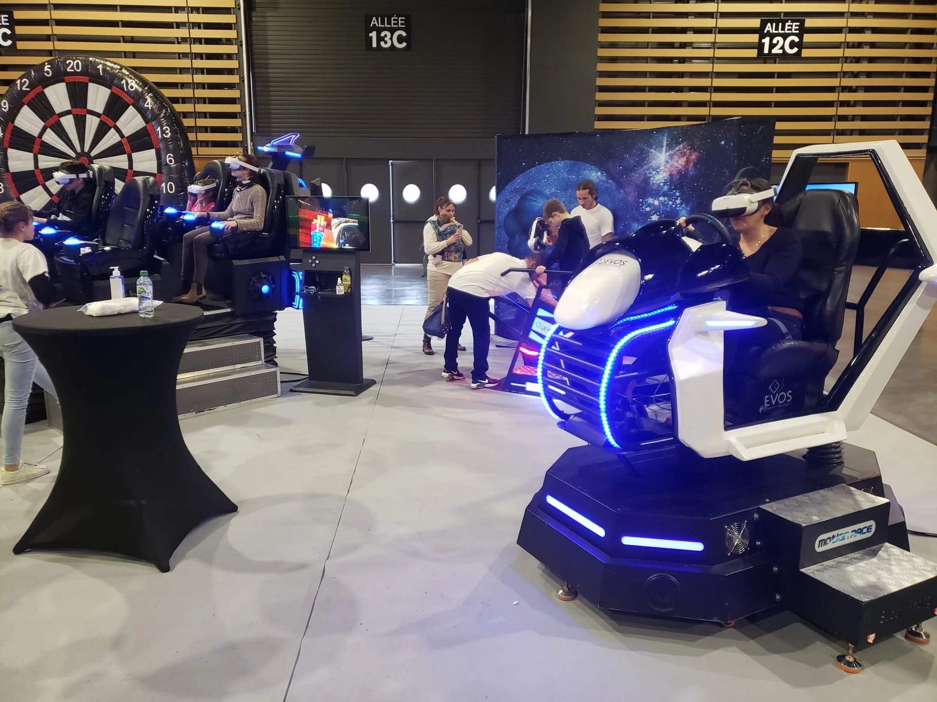 Participants essayant un simulateur scooter des neiges et une navette VR 4 places sur un salon professionnel