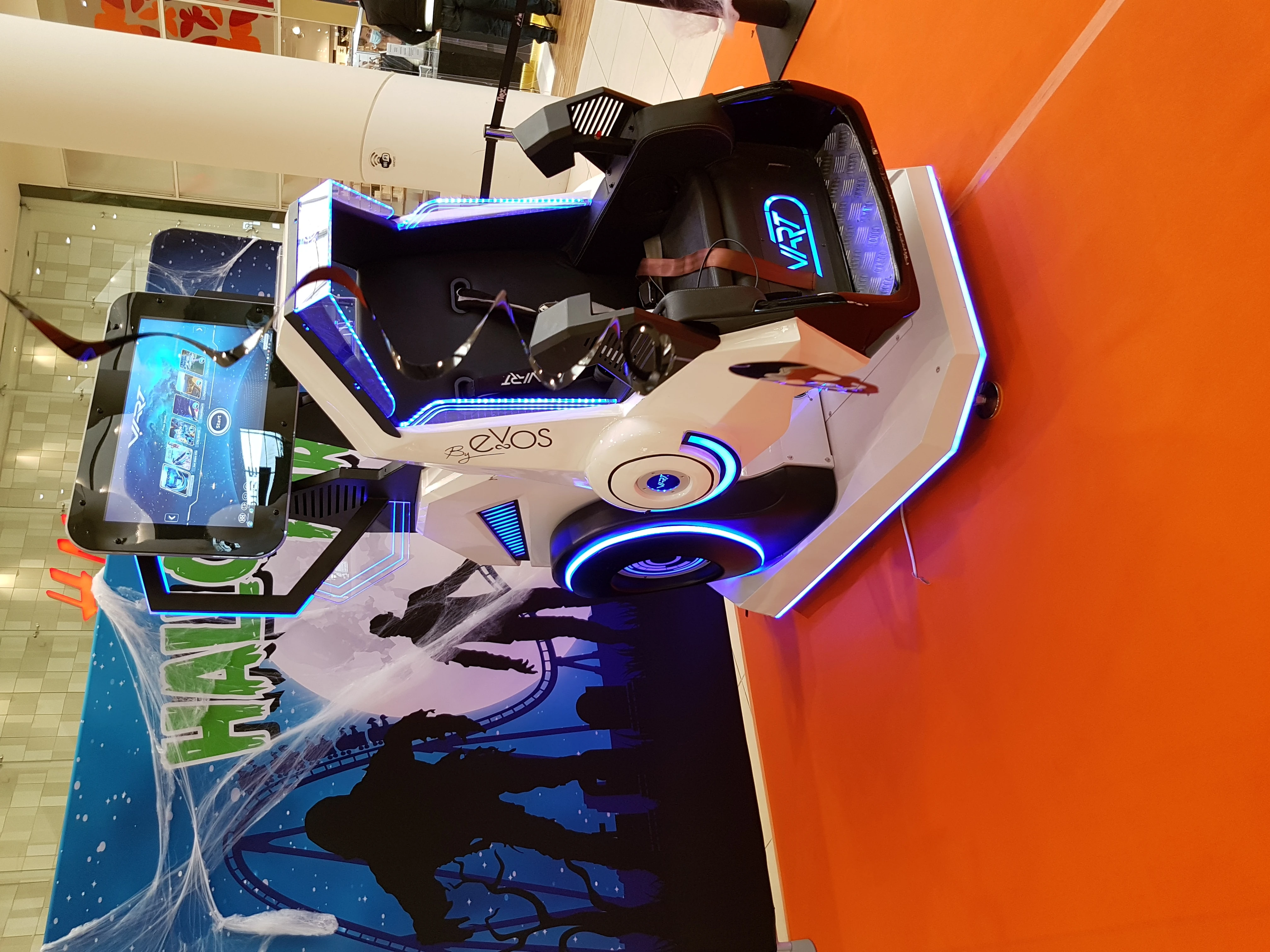 Visiteurs autour d'un simulateur 360 VR installé au cœur d'une galerie marchande