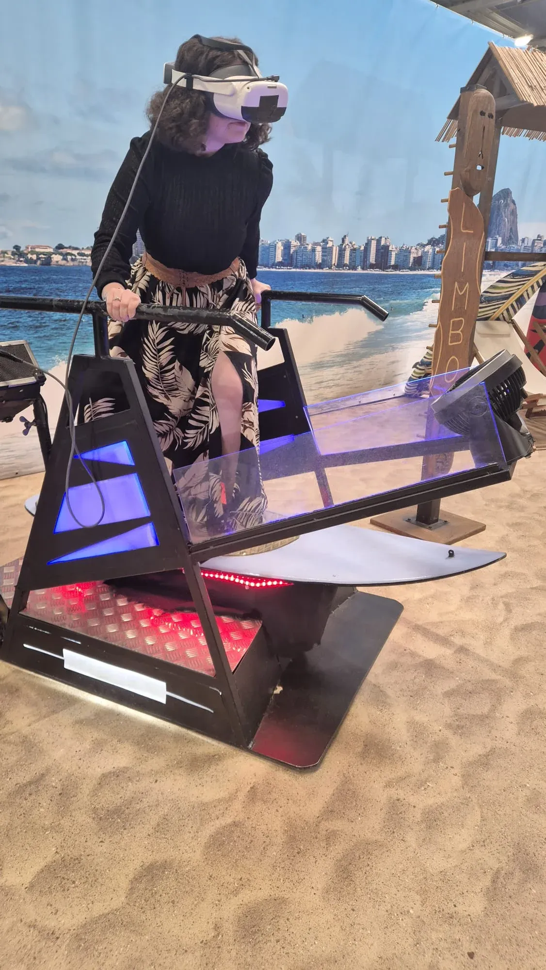 Jeune femme debout sur un simulateur surf VR lors d'une animation en espace commercial